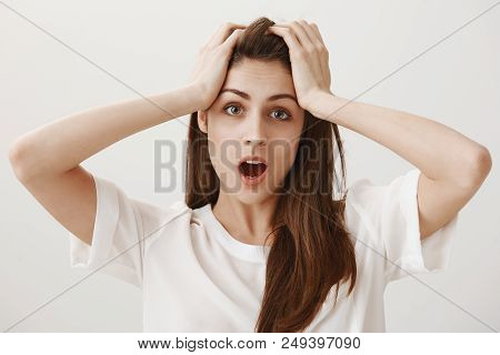 Deadline Is Near. Portrait Of Trobled And Stressed Attractive Young Woman Holding Hands On Head And 