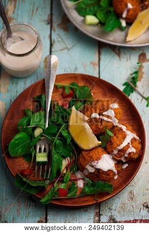 Beet Falafel With Tahina  Sauce And Green . Salad Selective Focus