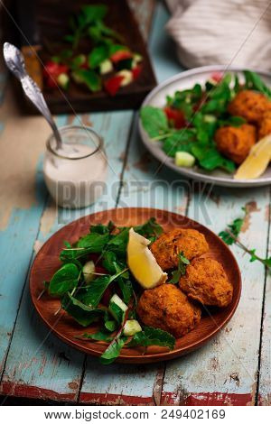 Beet Falafel With Tahina  Sauce And Green . Salad Selective Focus