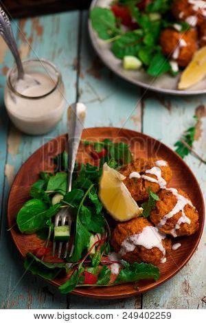 Beet Falafel With Tahina  Sauce And Green . Salad Selective Focus