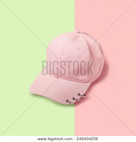 Blank Pink Baseball Cap With Rings On Pink Green Background.