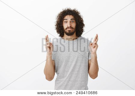 Shot Of Worried Stunned Attractive Bearded Hispanic Guy With Afro Hairstyle, Staring With Popped Eye