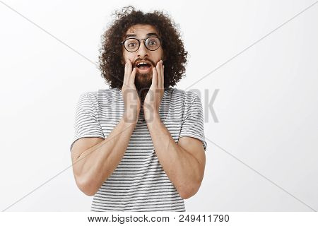 Portrait Of Shocked Overwhelmed Funny Eastern Guy With Afro Hairstyle, Gasping, Being Speechless Fro