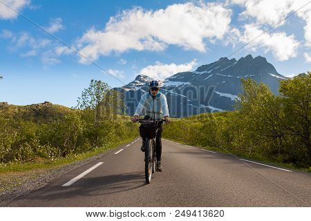 Mountain Bike Cyclist At Sphalt Road, Lofoten, Norway
