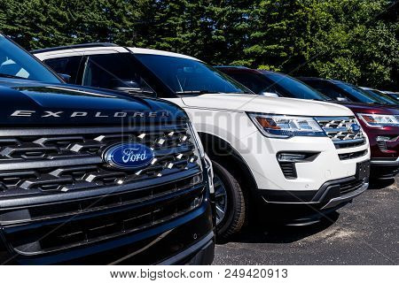 Indianapolis - Circa July 2018: Local Ford Car And Truck Dealership With American Flag. Ford Sells P