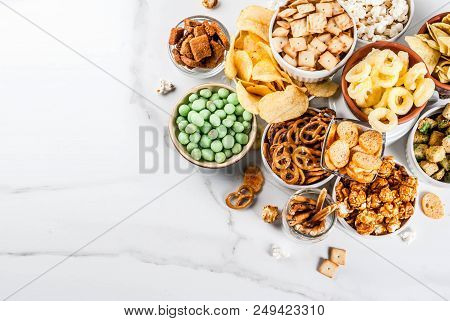 Variation Different Unhealthy Snacks Crackers, Sweet Salted Popcorn, Tortillas, Nuts, Straws, Bretse