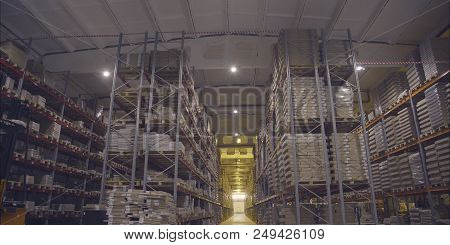 A Large Warehouse With Products From The Dcs. Large Storage Shelves. Warehouse Of Wooden Products.