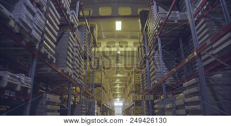 A Large Warehouse With Products From The Dcs. Large Storage Shelves. Warehouse Of Wooden Products.