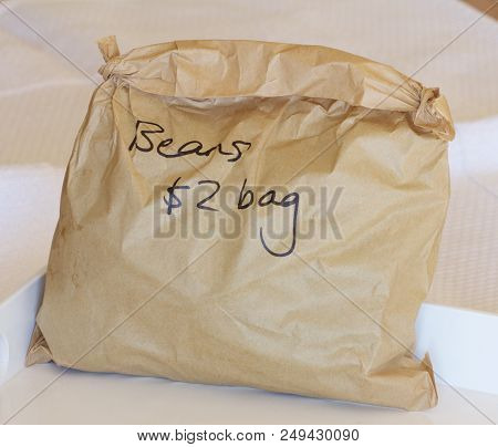 A Brown Paper Bag Of Fresh Beans For $2.00 In A Shop.