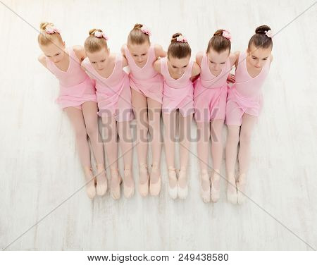 Little Ballerinas In Ballet Studio, Top View. Group Of Girls Practicing Position Sitting On Floor, C