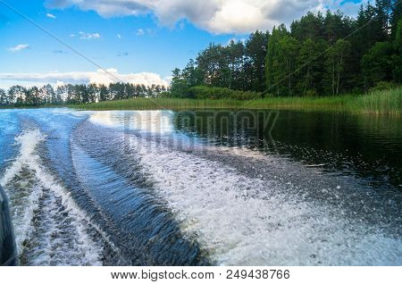 Foamy Trail On The Water Surface Behind The Fast Moving Motorboat. The Lake Seliger, Russia. Admirab