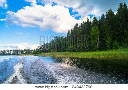 Foamy Trail On The Water Surface Behind The Fast Moving Motorboat. The Lake Seliger, Russia. Admirab