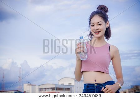 Healthy Girl's Drinking Water In The Bottle , Drink For Thirstily For Refreshing