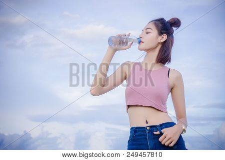 Healthy Girl's Drinking Water In The Bottle , Drink For Thirstily For Refreshing