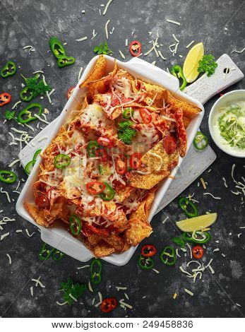 Maxican-style Tortilla Nachos Chips Topped With Tomato Salsa, Sliced Chilies And Melted Cheese Serve
