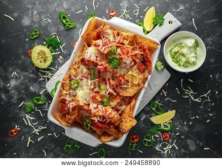 Maxican-style Tortilla Nachos Chips Topped With Tomato Salsa, Sliced Chilies And Melted Cheese Serve