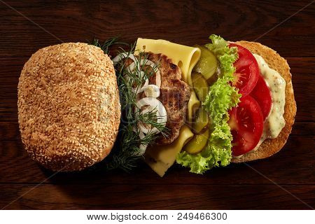 Close-up Of Delicious Fresh Home Made Burger With Piccoli, Lettuce, Cheese, Onion, Tomato, Dill And 
