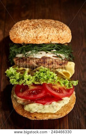 Close-up Of Delicious Fresh Home Made Burger With Piccoli, Lettuce, Cheese, Onion, Tomato, Dill And 