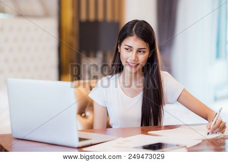 Asian Lady Student Do Home Work And See Online Learning On The Desk With Computer Notebook This Imma
