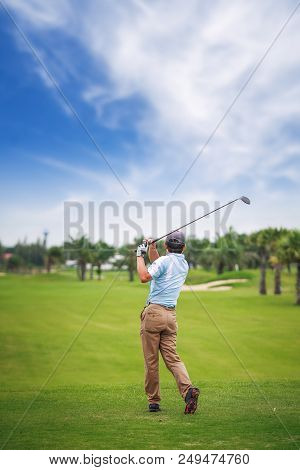 Asian Golf Player On Tee Off Green After Swing, This Immage Can Use For Relax, Sport, Exercise, Heal