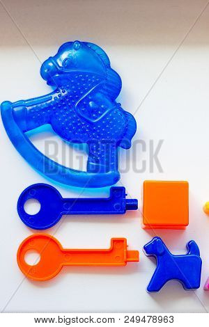 Set Of Toys For Babies On A White Table