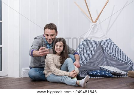 Father And Daughter Taking Selfie