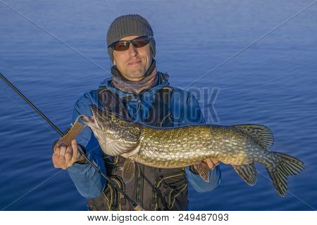 Fishing. Happy Fisherman With Big Pike Fish Trophy
