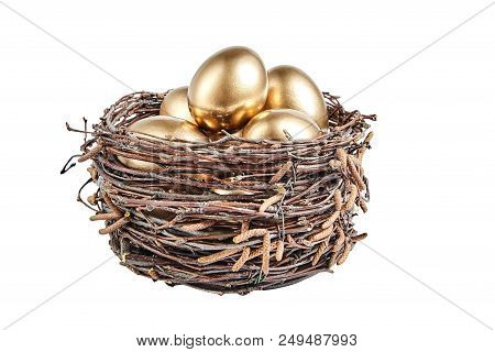 Golgen Eggs In A Basket Of Birch Branches. Painted Easter Chicken Egg In The Brown Nest