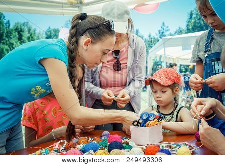 Zaporozhia/ukraine- June 2, 2018: Charity Family Festival-young Woman - Volunteer Explaining To Smal