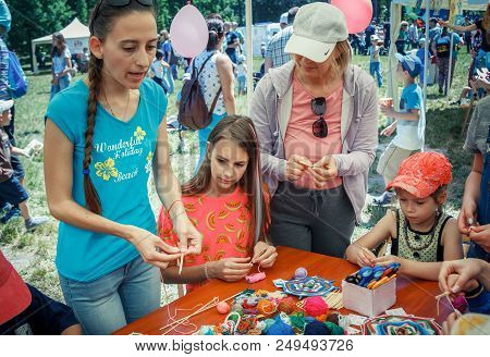 Zaporozhia/ukraine- June 2, 2018: Charity Family Festival-young Woman - Volunteer Explaining To Chil