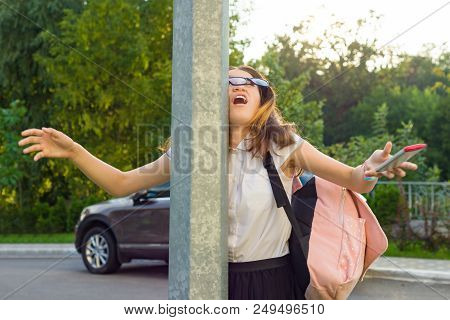 Portrait Of Young Inattentive Girl, Distracted By Mobile Phone. Girl Crashed Into Street Post, Dropp