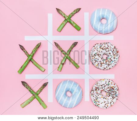 Tik Tak Toe Game With Donuts And Asparagus. Health Nutrition Concept Image