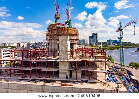 Construction Site With Cranes And Building With Blue Sky Background