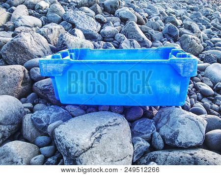 Plastic And Rubbery Rubbish Washed Up On A Stony Beach.  Photo Showing Pollution Problem. Dangerous 