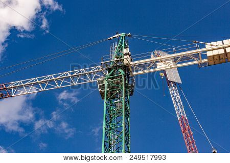 Construction Site With Cranes With Blue Sky Background