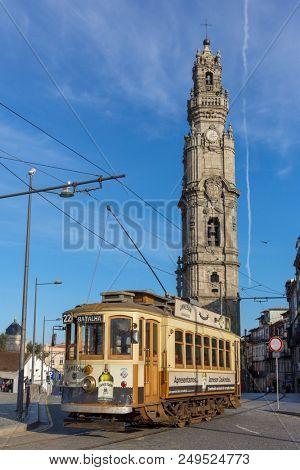 Porto, Portugal - January 16, 2018: Old tram and famous Torre dos Clerigos tower in Porto, Portugal.