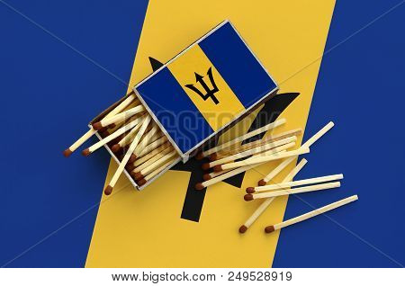 Barbados Flag  Is Shown On An Open Matchbox, From Which Several Matches Fall And Lies On A Large Fla