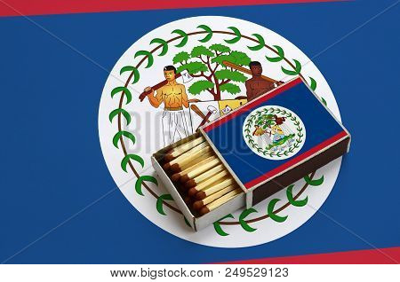 Belize Flag  Is Shown In An Open Matchbox, Which Is Filled With Matches And Lies On A Large Flag.