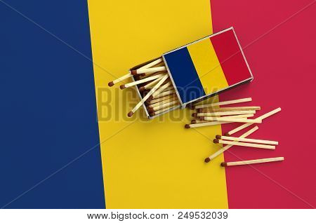 Chad Flag  Is Shown On An Open Matchbox, From Which Several Matches Fall And Lies On A Large Flag.