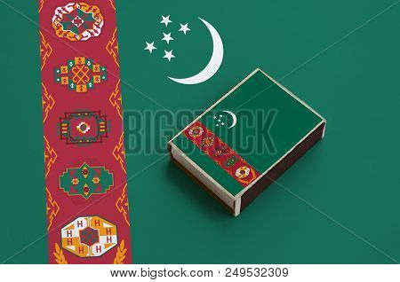 Turkmenistan Flag  Is Pictured On A Matchbox That Lies On A Large Flag.