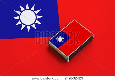 Taiwan Flag  Is Pictured On A Matchbox That Lies On A Large Flag.