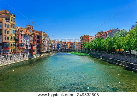 Colorful Red, Orange And Yellow Houses And Bridge Through River Onyar In Girona, Catalonia, Spain. S
