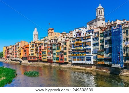 Colorful Red, Orange And Yellow Houses And Bridge Through River Onyar In Girona, Catalonia, Spain. S