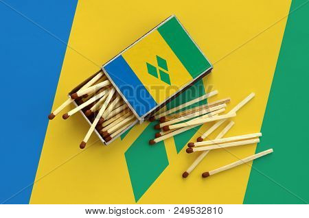 Saint Vincent And The Grenadines Flag  Is Shown On An Open Matchbox, From Which Several Matches Fall