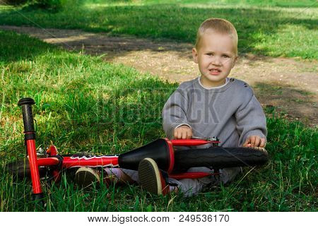 A Little Boy Dreams Of Becoming A Mechanic. The Guy Trains On A Bicycle. The Child Spins The Nuts On
