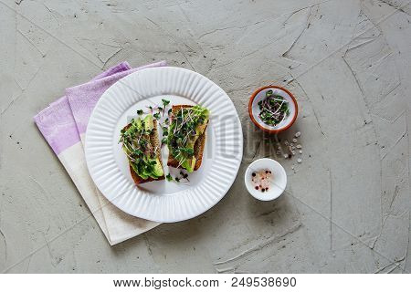 Balanced Vegan Breakfast Or Lunch Flat Lay. Healthy Avocado Toasts On Plate With Micro Greens Over L