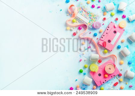 Pink Cassette Tapes In A Sweet Sounds Concept. Candies, Sprinkles And Marmalades On A Light Backgrou