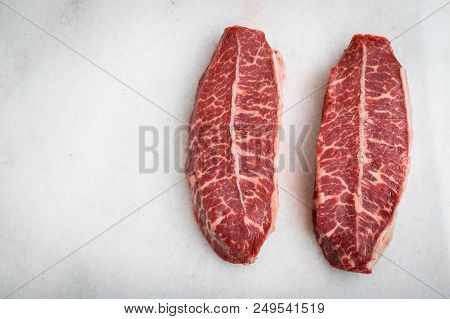 Raw Fresh Meat Top Blade Steaks On Light Background. Top View With Copy Space.