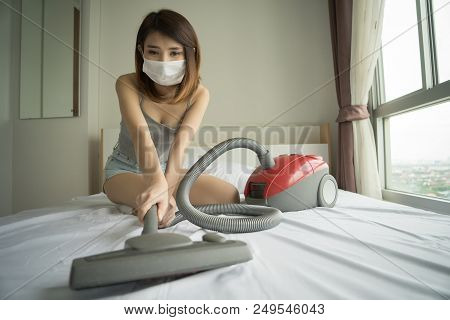 Woman Using Vacuum Cleaner While Cleaning White Bed At Home
Beautiful Young Asian Girl Cleaning Bed 
