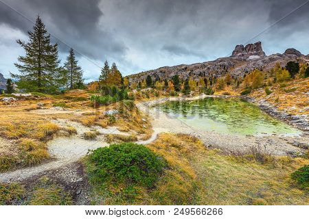 Stunning Autumn Landscape, Alpine Glacier Lake And Yellow Pine Trees, Limides Lake With High Mountai
